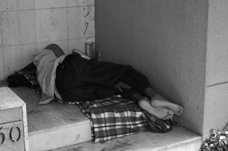 SLEEPING IN A CHURCH DOORWAY