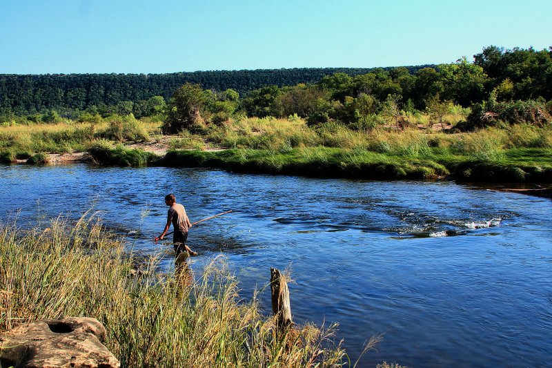 WADING DOWN THE RIVER WITH A RAKE