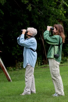 TWO BIRD WATCHERS WITH TWO SETS OF BINOCULARS