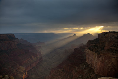 Dual exposures reveal the last rays of sun as they break through the clouds and illuminate the canyon below Cape Royal