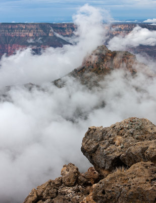 Mist rises from the canyon below Monument Point after summer monsoon 