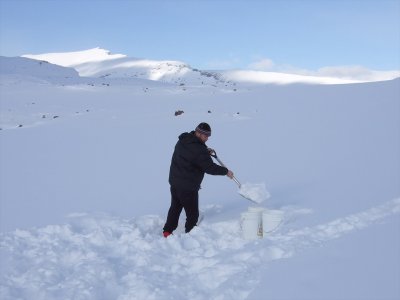 Aaron collecting snow to melt for water