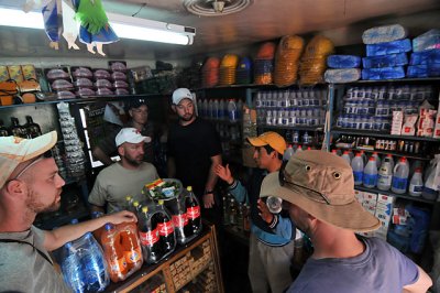 Tour guide explaining to us how miners buy dynamite, coca leaves, and alcohol in the miner's market in Potosi