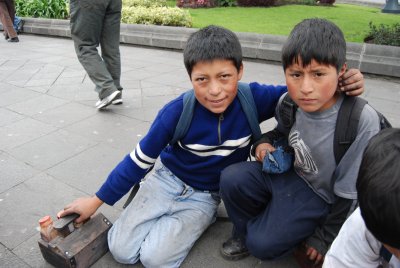 Young faces with tough eyes. Shoeshine boys in Quito.