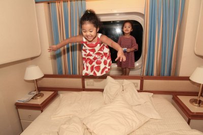 2 little kiddies jumping on the bed....