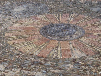 Ornate manhole cover on plaza on Montjuic 