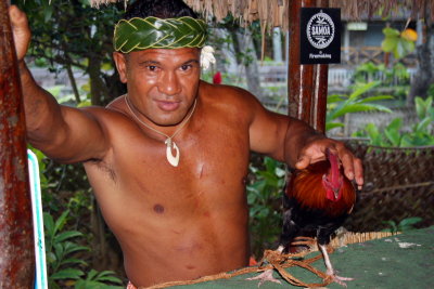 Samoan with his fighter cock, Polynesian village, Oahu, Hawaii, USA