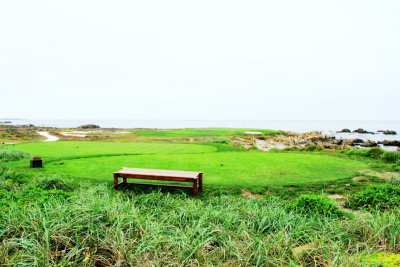 Golf and bench by the Pacific ocean, 17 Mile Drive, Monterey, California