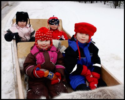 Happy Kaamanen children (towed by snow-mobile)