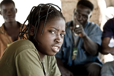 This girls in a thatch hut all day serving millet beer to drunken Burkinabe at 20 cents a bowl.
