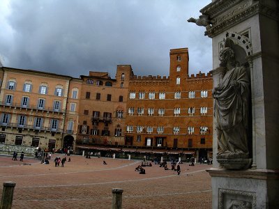 From the porch of the Palazzo Pubblico, looking across the Piazza del Campo to the towered Palazzo Sansedoni .. S9194