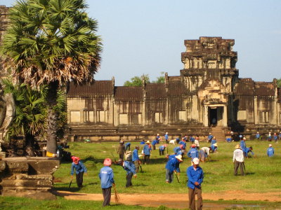 hand-cutting the grass at ankor wat