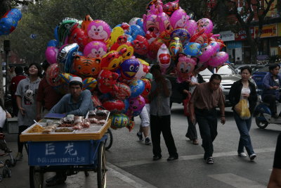 Uighur gent selling snacks, colourful balloons too