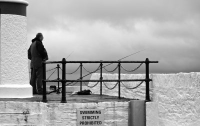 Fishing off the harbour wall, Laxey