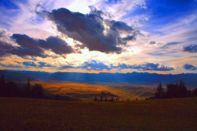 Sunlight bursts thru the clouds onto the valley below.jpg