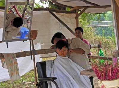 Haircut interrupted by curious photographers