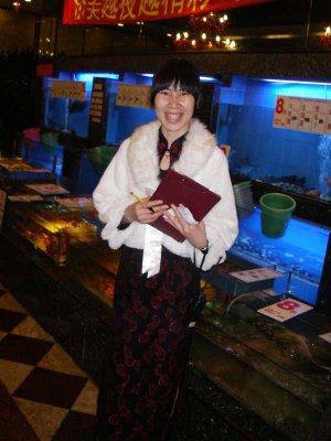 Our Hostess who takes your seafood orders next to the tanks 1923.jpg