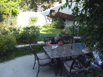Maryse writing in her journal in the garden.jpg