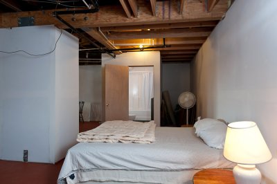 Bed and bathroom in basement