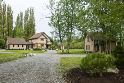Driveway to the house, separate cabin on the right