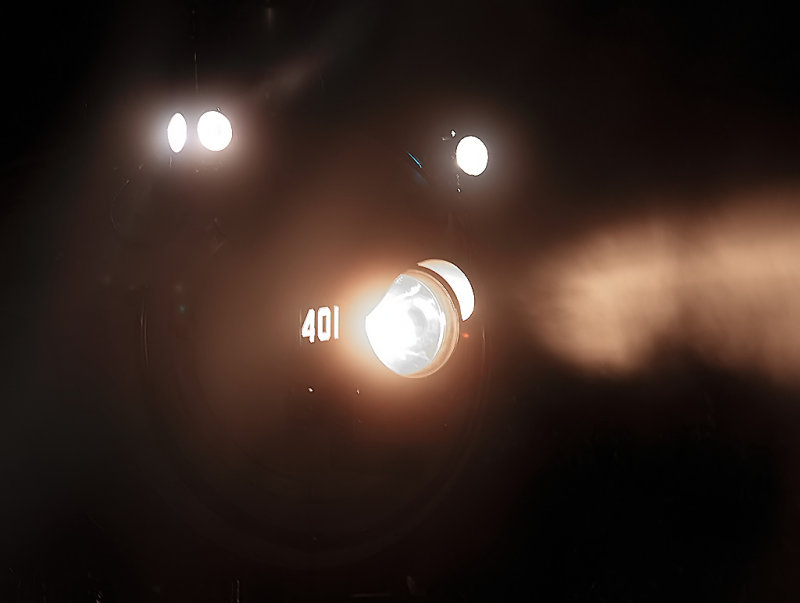 The headlight of the 401 lights up the misty night 