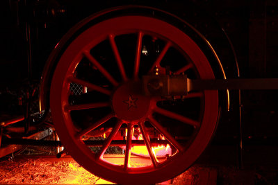 The glow from the firebox silhouettes the driver on Americas newest standard gauge steam locomotive, the Leviathan 
