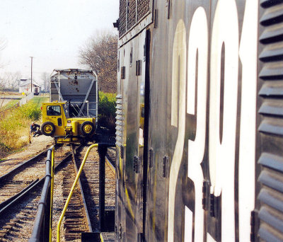 The Osram Sylvania trackmobile shoves a cut of empties out on the mainline.