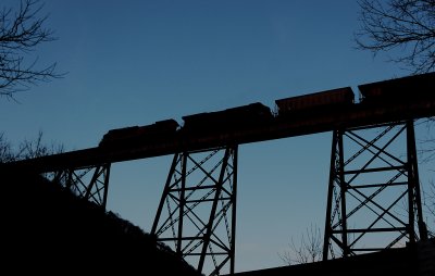 A Northbound empty coal train in silhouette, crosses the Copper Creek viaduct 