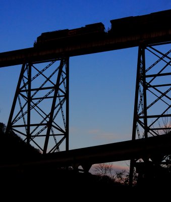 A Northbound CSX coal train crosses the massive Copper Creek bridge at dusk