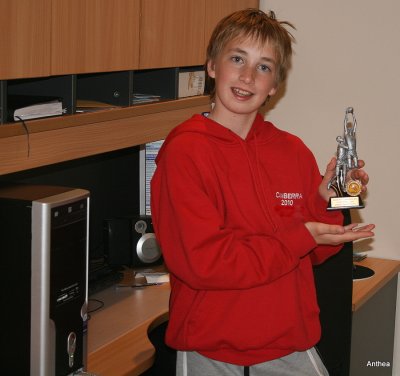 Back at home, a close up of Daniel and his trophy