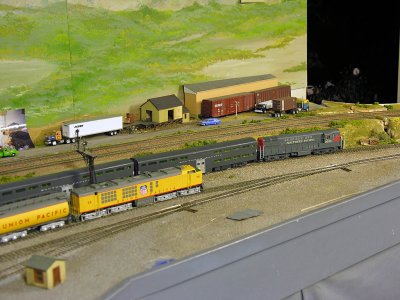 Espee commute train powered by a Fairbanks-Morse H24-66 Train Master (Atlas model) passes the UP Gas Turbine set (new from Athearn)