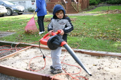 Blowing the leaves, and everything else, from the sandbox