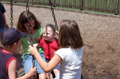 Playing on the tire swing with Brenna and Cameron