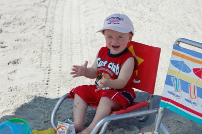 Liam enjoying the beach even though Mom forgot his hat and forced him to wear a pink one