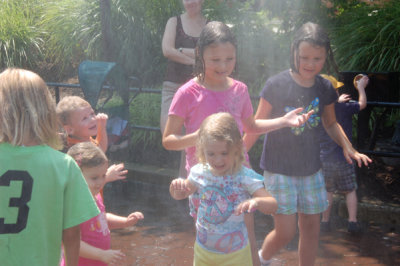 ALl the kids dancing around in the mister