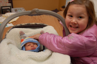 Reagan helping Liam with his hat
