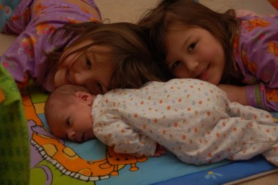 The girls teaching Liam about tummy time