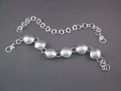 These 2 bracelets can be worn separately, together, or joined together to make a necklace about 19 inches in length.  Very versatile! the total weight of the necklace is about 40 grams.  The 'pillow bead' bracelet is highly polished on one side and lightly textured on the other side, so it can also be worn 2 ways.