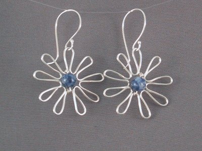 These sterling flower earrings feature a lapis bead in the centre.  The flower is approx 2.5 cm in diameter.