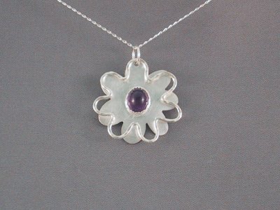 Floating flower pendant with ann 8x10 mm amethyst stone in the centre. pendant is 30mm in diameter.