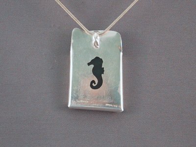 The back view of the bloodstone & moonstone pendant. Another under-sea inspiration with a seahorse cut-out on the backplate.