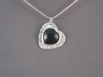 This heart pendant is about 26 x 27 mm in diameter, with an onyx heart in the centre.