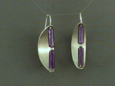 Two amethyst tube-shaped beads separated by a small sterling bead, with a curved sterling reflector.