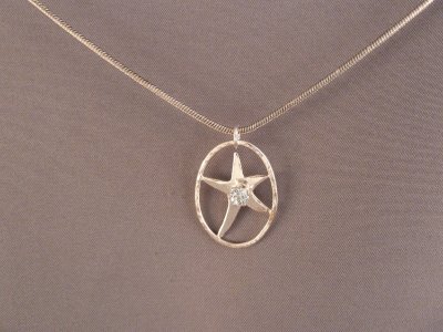 Sterling starfish pendant with blue CZ.