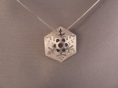 Two-part sterling silver snowflake.