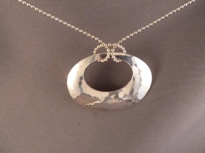 Hammered sterling silver oval.