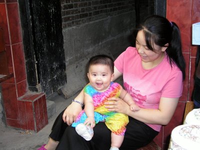 Xian - Muslim bazaar vendor with baby