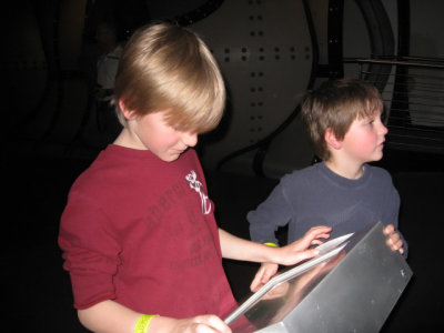 Nick reads about the fish while Jake watches them.