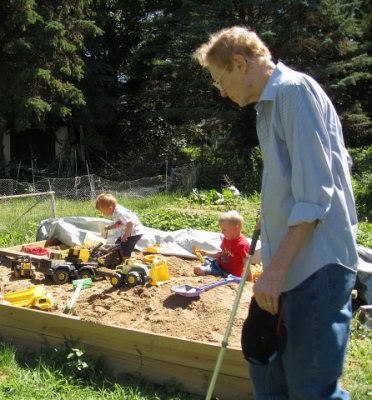 Grandpa overseeing Adam and his friend Joseph in the sandbox