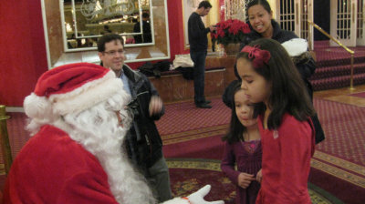 Proud parents as the girls tell Santa what their Christmas wishes are.